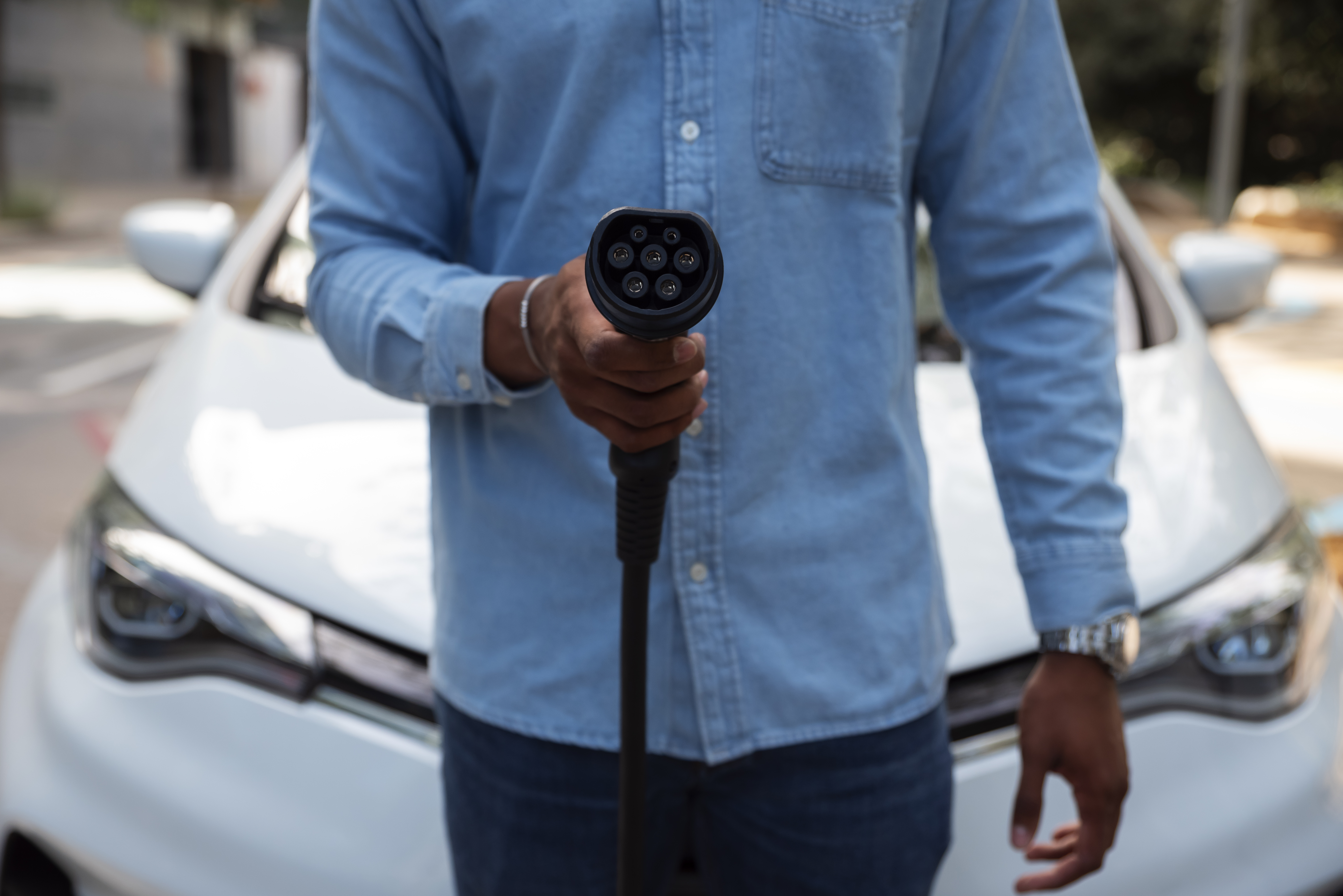 front-view-man-holding-car-charger